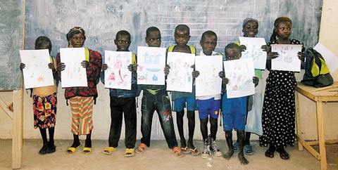 
	2012년 동아프리카‘차드’에서의 미술수업 시간. 어린이들이 그린 그림을 펼쳐보이고 있다.
